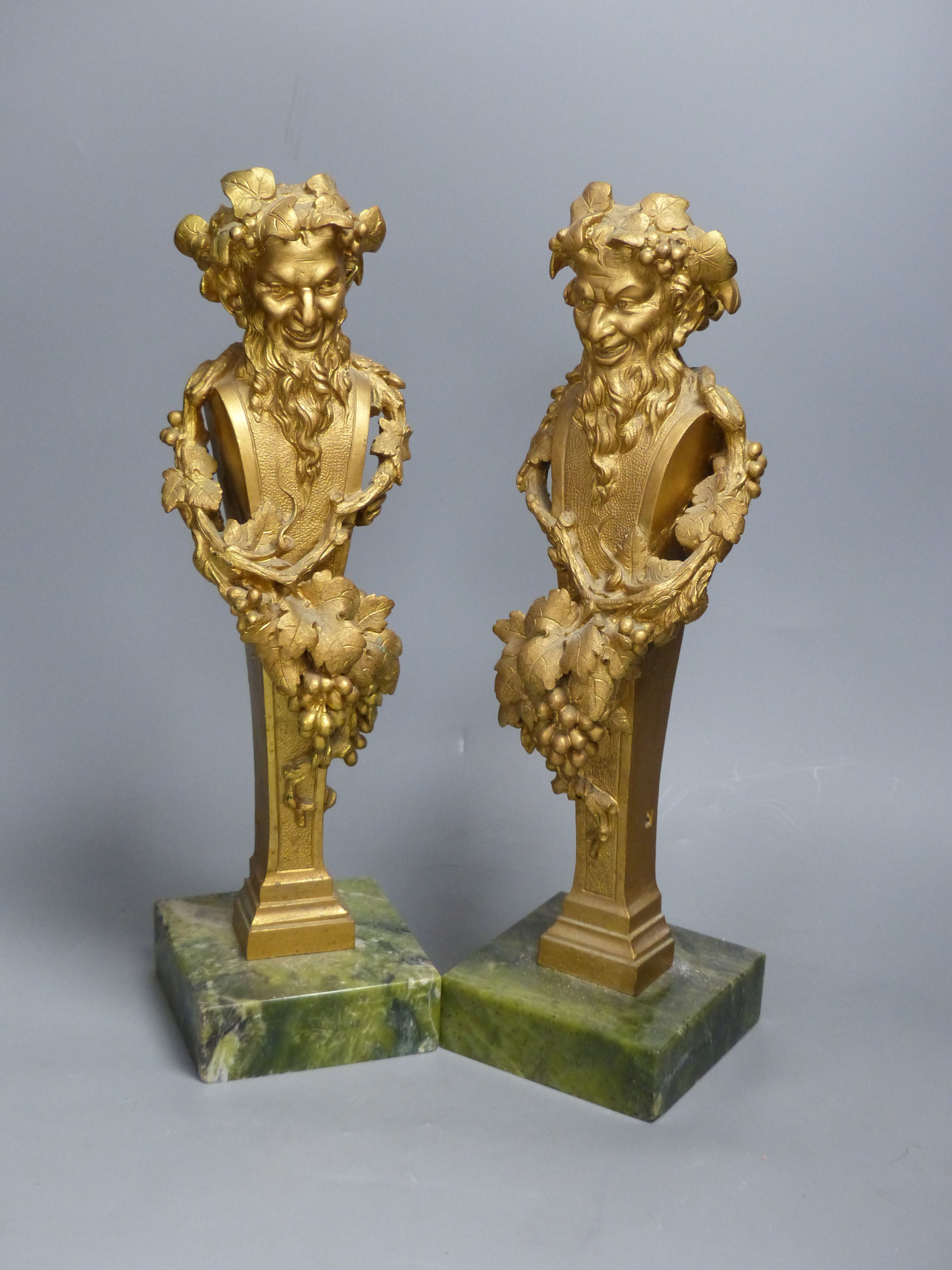 A pair of gilt bronze 'Bacchus' mounts, on Connemara marble bases, height 40cm